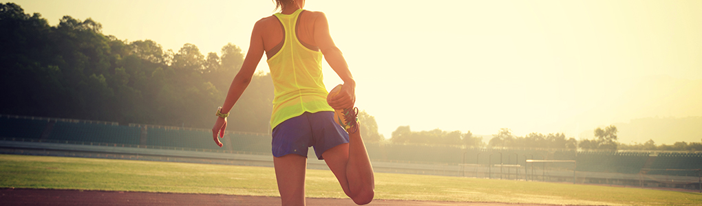 Woman stretching before a run after having her knee cared for by an orthopedic specialist.